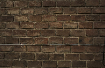 Background of red brick wall with wire