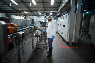 Factory engineer operating machine in factory