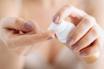Poster woman hands applying moisturizing cream to her skin © Andrey Cherkasov
