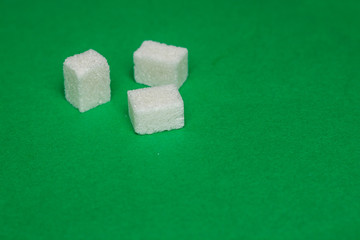 sugar cubes on a green background