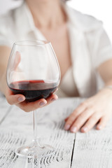 Sexy woman in white holding wine glass