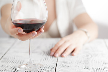 Sexy woman in white holding wine glass