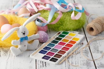 Festive easter decoration on white table with pastel color eggs
