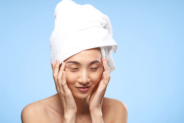 happy woman in a white towel, blue background