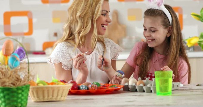 Easter  painting – mother  with daughter  coloring eggs