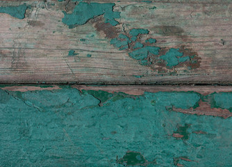 Obraz premium Wooden background. Turquoise cracked paint on wooden boards.