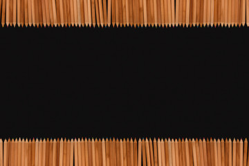 Frame of color pencils on black background