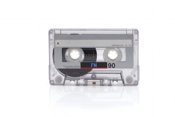 Vintage black compact cassette on white background