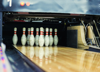Pins at the end of a bowling alley,Skittles for bowling,bowling game