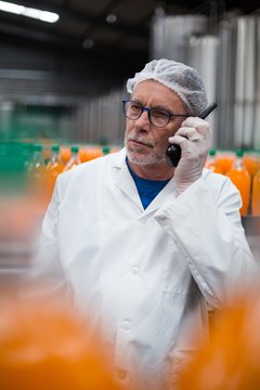 Factory Engineer Talking On Walkie Talkie