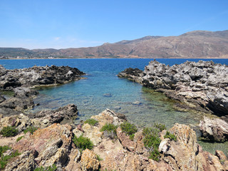 Fototapeta na wymiar Rocky coast at the port of Kissamos on the background Korikos Peninsula, western Crete, Greece, Mediterranean Sea