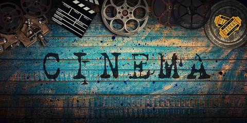 Cinema concept of vintage film reels, clapperboard and projector.