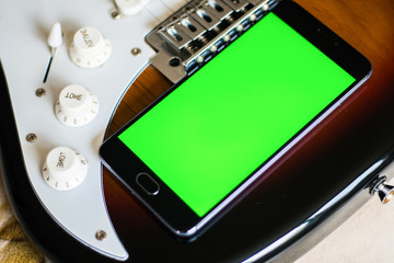 on an acoustic guitar Smartphone with green screen 