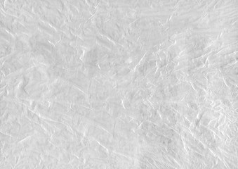 White abstract background of cellophane and paper texture