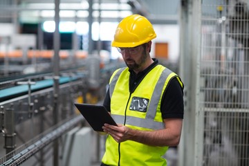 Factory worker using a digital tablet