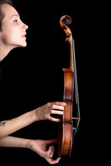 woman profile and violin on black background