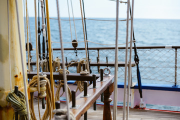 Blue sky and vintage 19th-century sailing ship mast, sunny background
