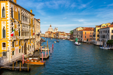 Fototapeta na wymiar View of the canal with boats and gondolas in Venice, Italy. Venice is a popular tourist destination of Europe