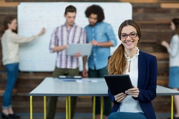 Portrait of female business executive with tablet 