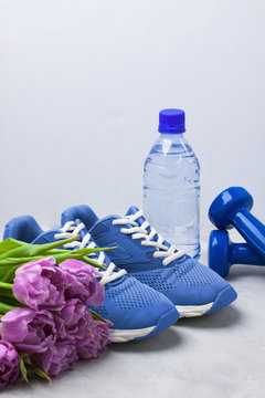 Spring sport composition with blue dumbbells purple tulips.
