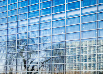 Fototapeta na wymiar Reflection of the European Parliament building in the glass facade of the Council of Europe building in Strasbourg, France 