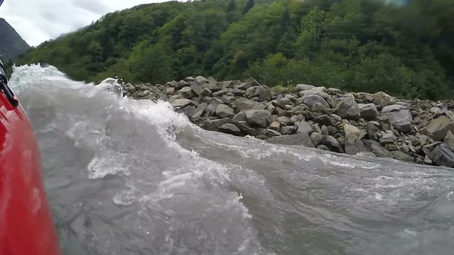 Rafting boat almost overturned with large waves, team trying to keep balance