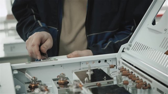 Microchip production factory. Technological process. Assembling the board. Computer expert. Manufacturing. Engineering. Chip. Professional. Technician.