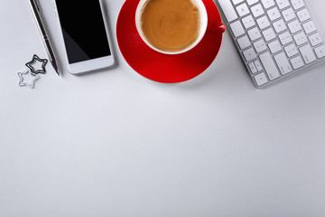 Modern workplace with cup of coffee