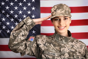 Saluting female soldier with USA flag on background