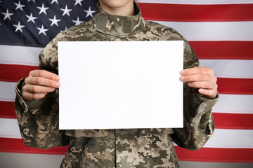 Female soldier with blank poster on flag background, closeup