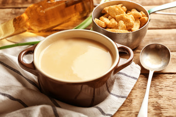 Delicious beer cheese soup with croutons on table