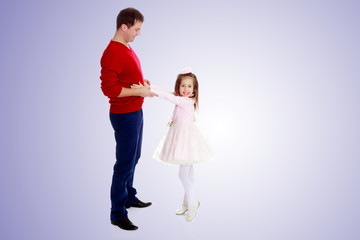 Little girl pulls her hands to his daddy.