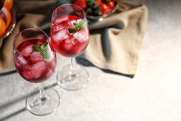 Glasses of delicious wine spritzer on table