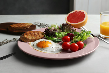 Tasty breakfast with egg and juice on table