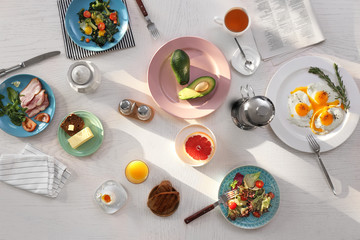 Tasty breakfast with fried eggs on table