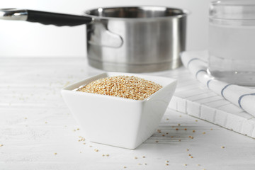 Bowl with quinoa seeds on kitchen table