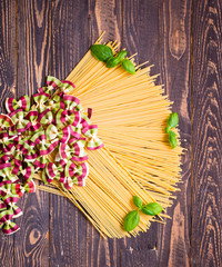 Close-up of decorating Italian pasta. On a wooden background