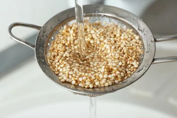  Washing quinoa seeds in sieve, closeup © Africa Studio