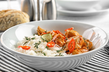 PLate with chicken tikka masala and rice, closeup