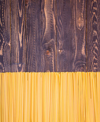 Close-up of decorating Italian pasta. On a wooden background