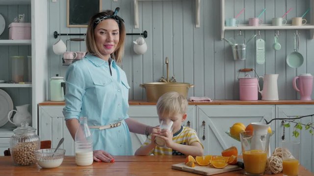 Mom Son Spend Time Holiday Eating Breakfast, mother and boy child on kichen, happy family