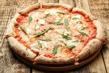 Fresh pizza Four Cheese on wooden background closeup