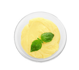 Creamy cheese and basil leaves in glass bowl, isolated on white