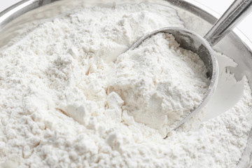 Metal scoop in flour, closeup