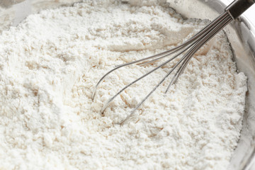 Bowl with flour and whisk, closeup