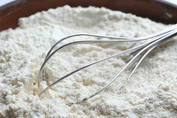 Whisk on flour, closeup