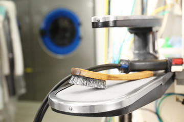 Steam spotting table with brush at dry-cleaning