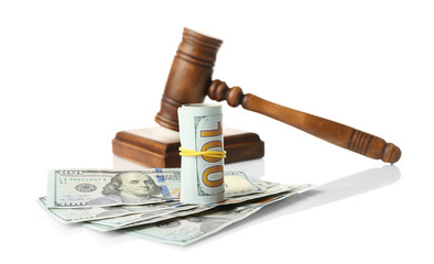 Money and judge's gavel on white background