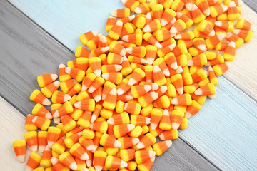 Colorful Halloween candy corns on wooden background