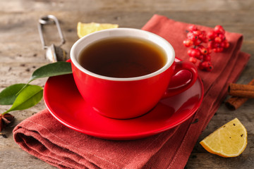 Cup of aromatic tea on napkin